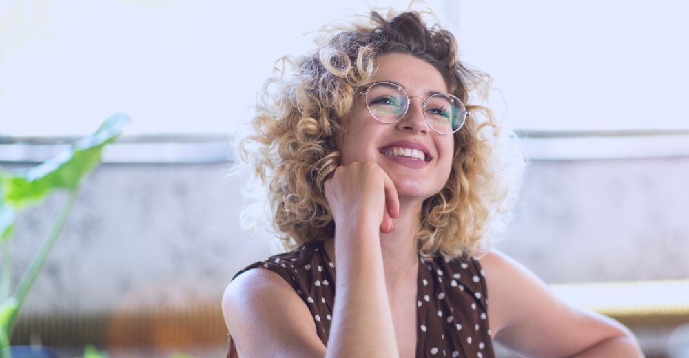 women smiling with glasses on
