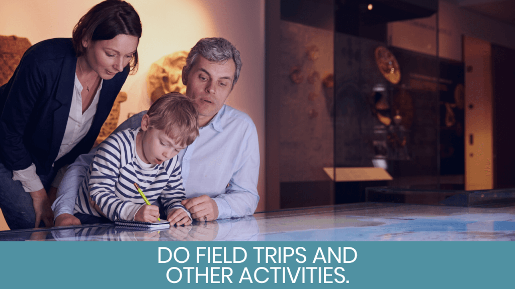 Parents helping child write on notebook