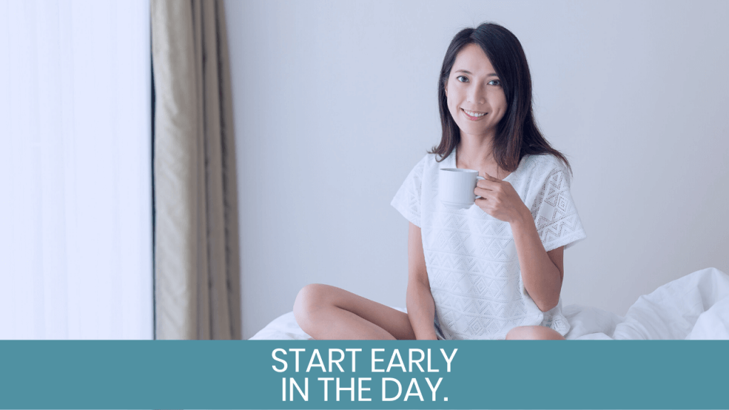 Woman smiling on bed with coffee mug