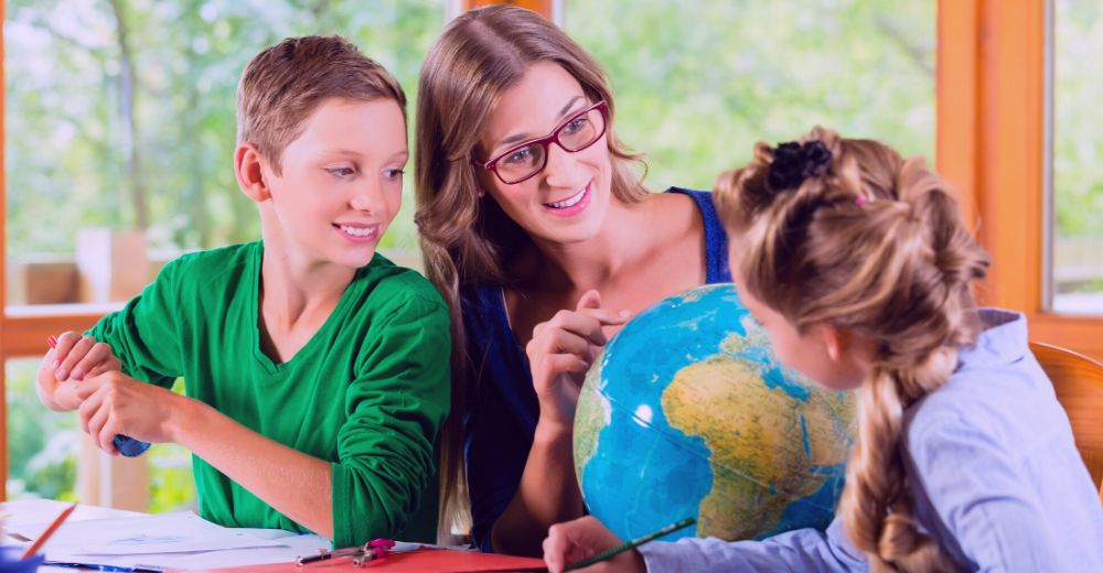 Mom teaching their kids with a world globe
