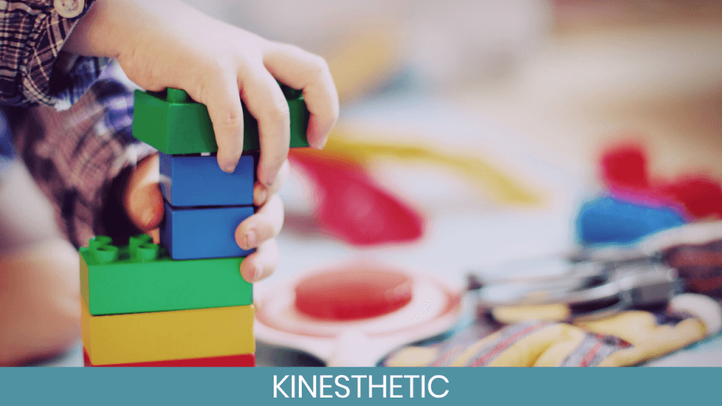 Child's hands building with colorful blocks