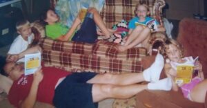 Old picture of family lying on the living room reading books