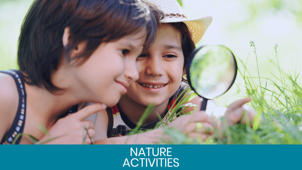 Kids looking at grass with a magnifying glass