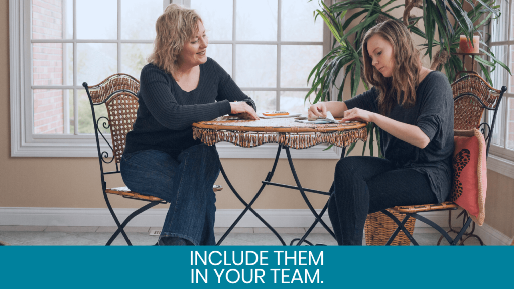 Mom and teenage girl sitting on desk and talking